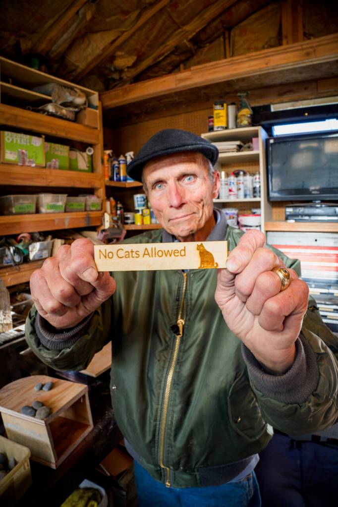 (Photo by David Welton)
John Schmidt has many amusing elements that can be attached to his birdhouses, including this No Cats Allowed sign.