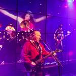 (Photo by Luisa Loi)
Don Hanson performs Alone Again Or by Love, as a woman in a red dress wildly dances in the background.