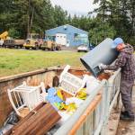 (Photo by Ian Tiessen)
Steve Hipskind empties a trash bin into the dump at the Island County Solid Waste Complex.