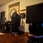 Tendo, head monk at Tahoma One Drop Zen Monastery, beats a semantron before chanting. (Photo by Sam Fletcher)