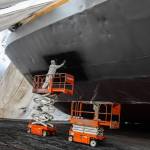 Photo by Luisa Loi
Tyler Allen, also known as peanut by his coworkers, paints the Madison Bay on a Tuesday morning. The boat is about 17 feet tall from the bottom to the main deck and was covered under a giant tent at the time this photo was taken. Madison Bay is inspected every five years by the American Bureau of Shipping, and all the necessary renovations, including the replacement of the anodes, are done at Nichols Brothers Boat Builders.