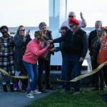 Members of the City of Oak Harbor and Sculpture Northwest cut the ribbon for the Angel de Creatividad, Oak Harbors new 40-foot sculpture at Flintstone Park. (Photo by Sam Fletcher)