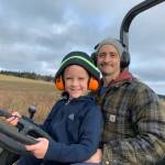 Photo provided
Bart Crowder, president of the Farm Bureau, drives a tractor with his son on the 1902 Ranch in Coupeville.