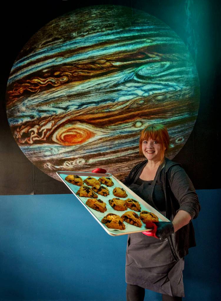 Photo by David Welton
Laura Wills holds a tray of marionberry scones in Jupiter Coffee.