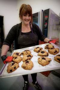 Photo by David Welton
Laura Wills holds up a tray of freshly baked marionberry scones.