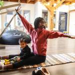 Photo by Luisa Loi
Shelby Novak stretches with the help of a spring board while her son Glenn provides emotional support.
