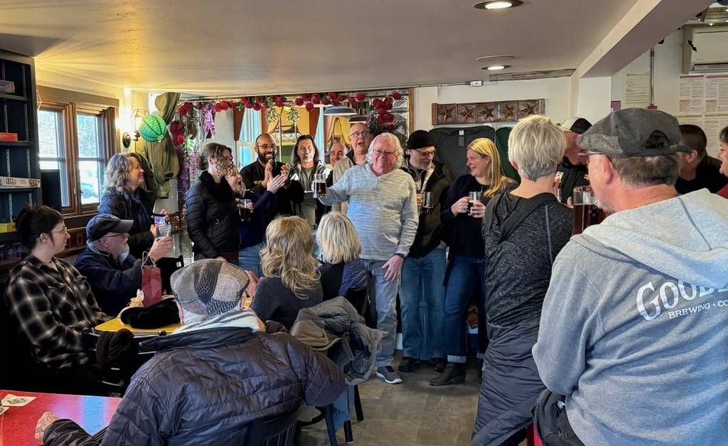 (Photo provided)
Well-wishers raise a glass to retiring city employee Bob Herzberg in Double Bluff Brewing Company.