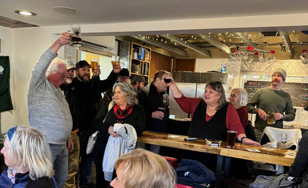 (Photo provided)
Well-wishers raise a glass to retiring city employee Bob Herzberg in Double Bluff Brewing Company.
