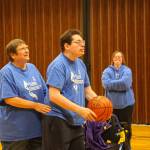 (Photo by Luisa Loi)
Coach Shari Mays assists her son Jason Mays before he shoots the ball. Her other son, Matthew Mays, also volunteers as a coach.