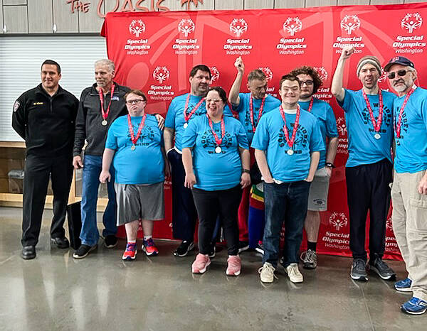 (Photo provided) South Whidbey Winds basketball team placed second at the regional competition in Marysville on Feb. 8. At left, a firefighter who handed out medals poses with Assistant Coach Rocky Hawkins, Michael Hawkins, Ryan Hagar, Mira Mostafavinassab, Greg Bailey, Conner Weaver, Nicky Whitehouse, Leo Black and Coach Mike Etzell.