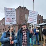 (Photo by Scott Chaplin)
Susan Prescott and Michael Seraphinoff displayed signs addressing the recent firings of federal employees.