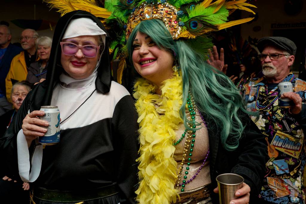 Alison Donham, left, and Tessa Karno dress in all the colors of Mardi Gras.