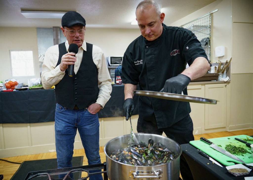 Michael Weeks, at left, observes as Robert Spaulding cooks some mussels to impress the judges. Spaulding, who lost by a small margin, is a chef at Elliotts Oyster House in Seattle.