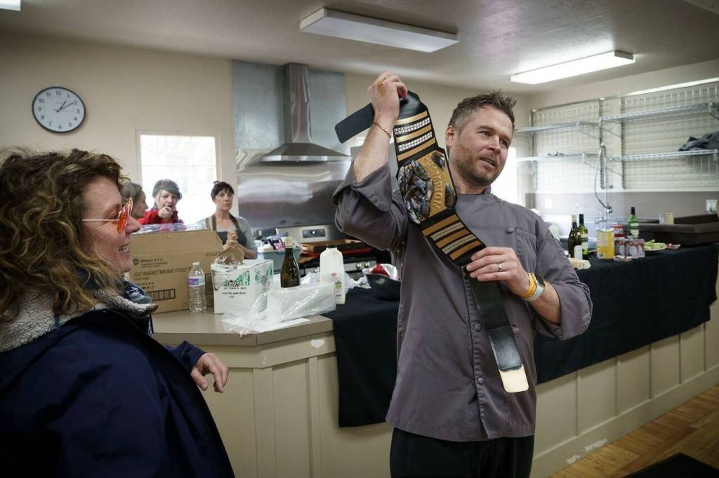 Mussel Tussle winner Michael Wieczorek holds his mussel belt for the crowd to see. The next day, Chef Michael Weeks from Callens dueled against Sean Prater from Captain Whidbey, who won.