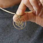 (Photo by Kira Erickson/South Whidbey Record)
Chris Soukup shows off his own necklace, the outline of Whidbey Island carved into a U.S. 50-cent piece. He kept the wings of the eagle on the half dollar.