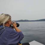 (Photo by Bambi Miller)
Photographer Cindi Rausch scans the water for whales.