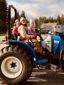 Jake Stewart of Sweetwater Farm on his tractor with next generation farmers.