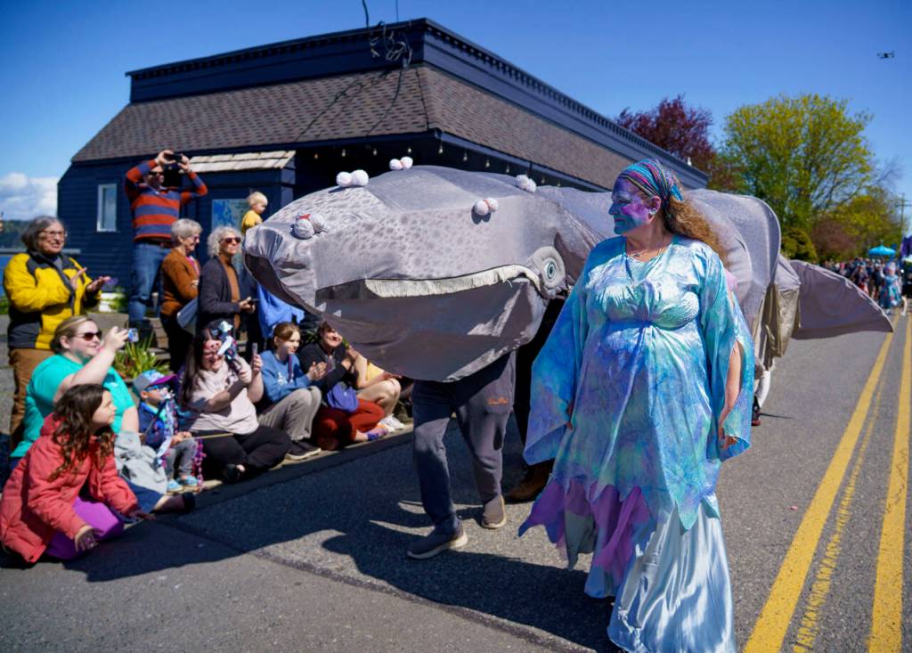 Sea witch Stephanie Raymond walks in front of Patch, the gray whale puppet brought to life by a group of puppeteers that included Filmmaker Dylan Thuras from Atlas Obscura. (Photo by David Welton)
