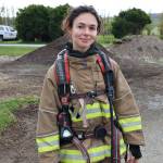 (Photo by John Fisken)
Freelance reporter Luisa Loi poses for a photo after experiencing the first round of fires in the Swanton Road home. As of Monday night, her shoulders still feel sore from carrying the self-contained breathing apparatus. Perhaps its time to hit the gym.