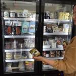 Sometimes customers request a certain product they once tasted by cant remember by name. That sends Whidbey Provisions owner Katie Oakes Stevens off on a foodie scavenger hunt. Here she shows off one such quest, a fermented spicy brown mustard made by OlyKraut of Olympia. (Photo by Patricia Guthrie)