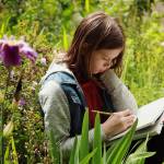 An early childhood student at Whidbey Island Waldorf School works outside on a botany lesson. (Photo provided)