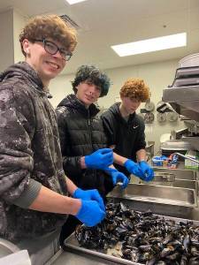 (Photo by Paige Mueller)
Students shuck mussels for the March Musselfest.
