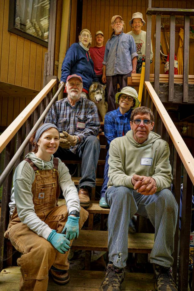 Captain Adam Breedloves team pose on rebuilt steps and railing at Marianne Edain and Steve Ericksons Clinton home.