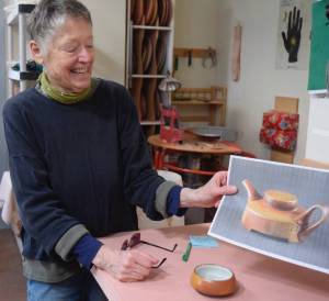(Photo by Patricia Guthrie)
Artist Robbie Lobell looks over some of her ceramic designs for the Cook on Clay business she and Maryon Attwood founded 15 years ago. The company is now based in Ohio with new owners; Lobell and Atwood will continue to live and create in Langley.