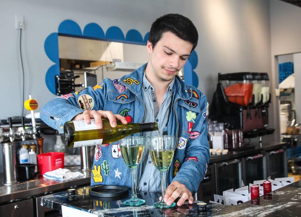 An employee pours a drink.