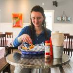 Photos by Luisa Loi
Sophia Jones enjoys some fish and chips at the restaurant she opened last month with her partner, Ben Jones.