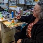 Sue Traher paints a wooden egg as an example for those who will be taking the crafts class offered at the Good Cheer Thrift Store in Langley. (Olivia Vanni / The Herald)