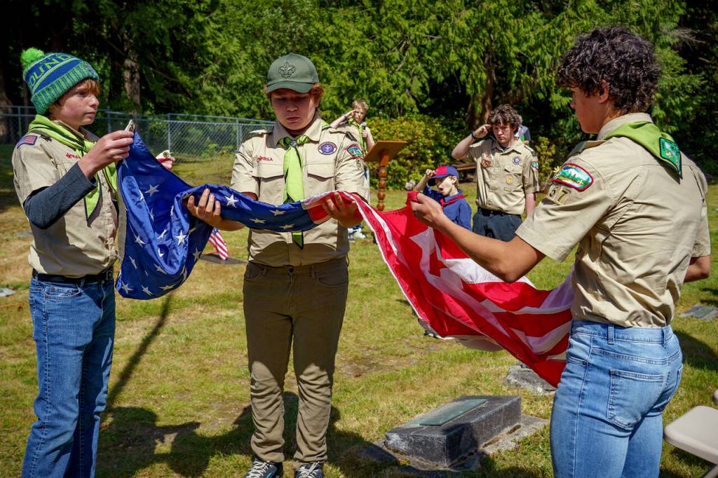 Photo by David Welton
From left, Boy Scouts in the ceremony are Wyatt Walsh (in the beanie), Jonah Macarro, Carter Kalb (leading the ceremony), Parker Hammons (saluting), and Jasper Ohlin.