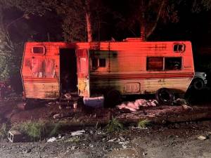 Photo by Central Whidbey Island Fire and Rescue
Two people were trying to get their vehicle running on Central Whidbey when it caught fire Friday night, igniting a nearby trailer where they lived.