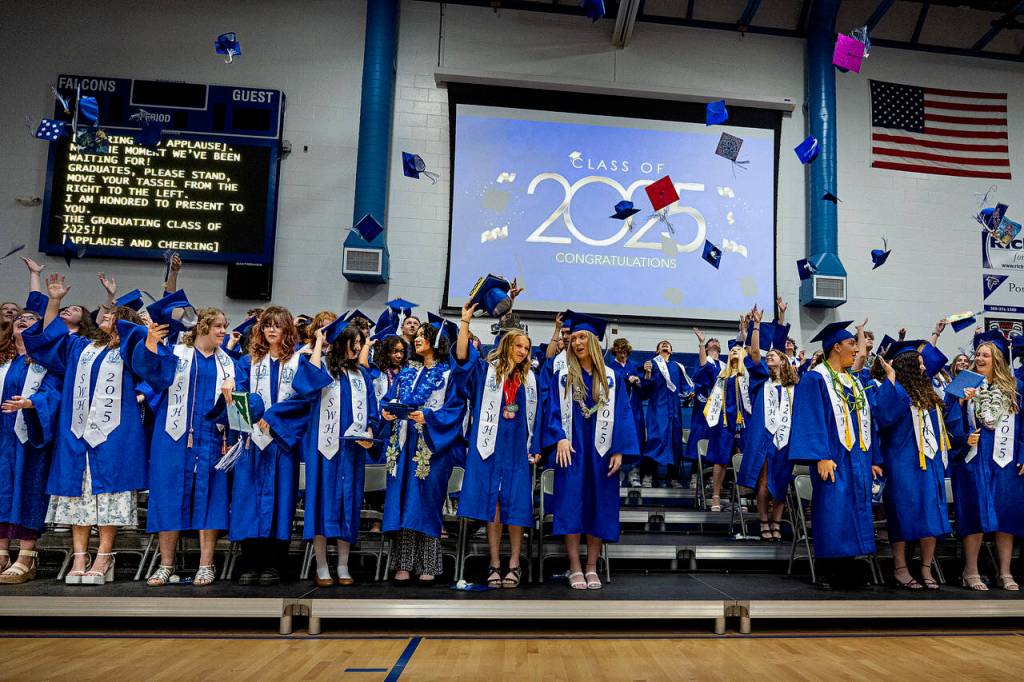 South Whidbey grads toss their caps in the air after graduating.