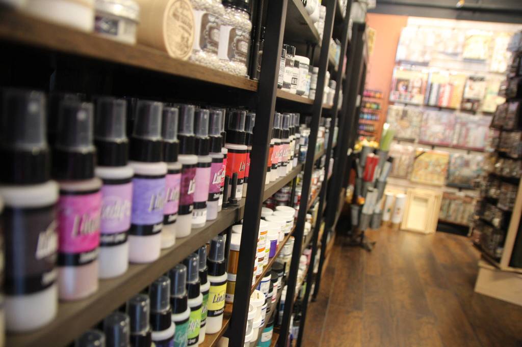 Rows of colorful paint on the shelves.