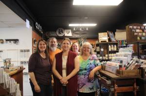 Business owner Trish Sillavan, at center, stands inside Ember and Elegance with vendors Jobeth Glenday, Tim Goette, Maria Fazio and Wendy Grimsley,
