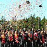 Graduates throw their caps in celebration. (Photo by Marquette Cunningham)