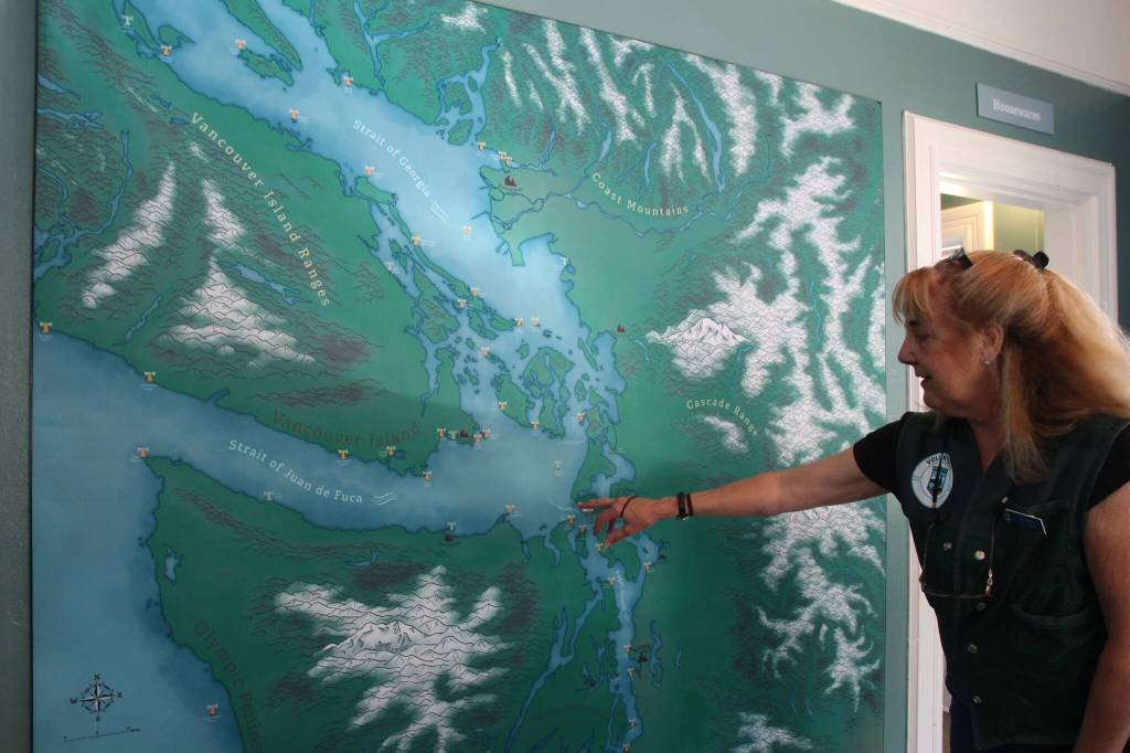 Retired Speech and Language Pathologist turned Docent Volunteer, Jeanne Amundsen, describes the route ships take before encountering the Admiralty Head Lighthouse. (Photo by Marina Blatt)