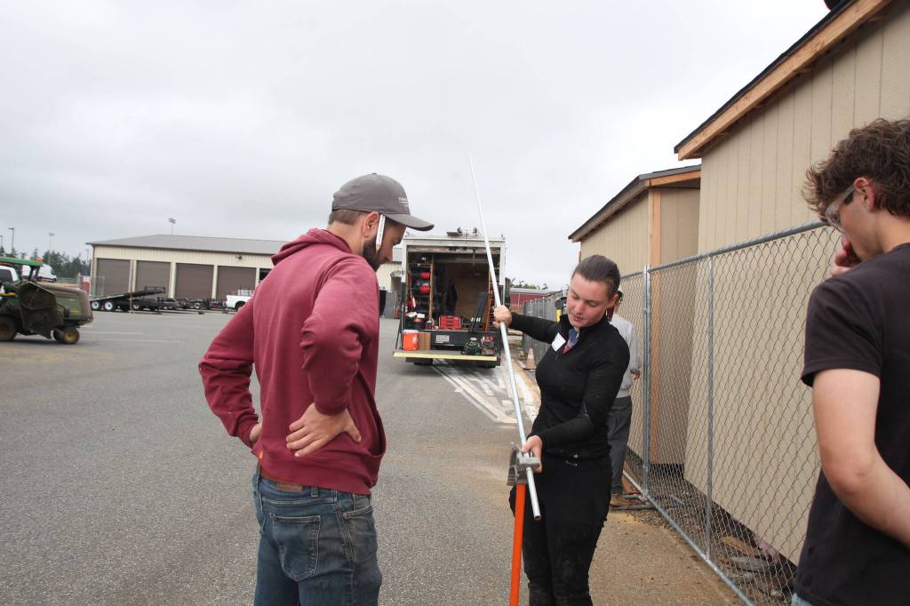 Photos by Marina Blatt
Trainee Rose Shirley and Project Manager Blake Mennella from Whidbey Sun & Wind talk to a student about applying solar paneling.