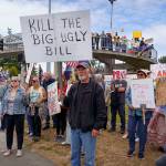 This sign references President Donald Trumps $4 trillion tax and spending bill, as said by Tesla CEO Elon Musk.