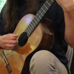 Kevin Cooper strums the guitar (Photo by Allyson Ballard)