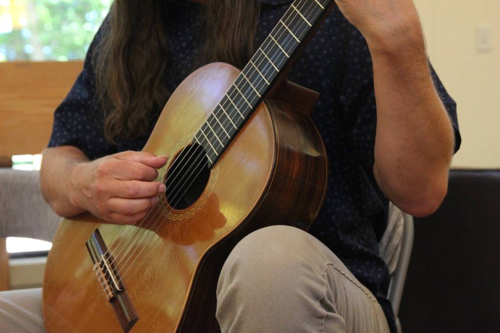 Kevin Cooper strums the guitar (Photo by Allyson Ballard)