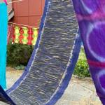 The advanced class covered topics such as color mixing, fabric selection, fabric preparation and safety. The students colorful fabrics dry on lines
(Photo by Matt Neinhuis)