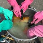 Students wear protective gloves while dying their fabrics to protect themselves from harmful chemicals (Photo by Matt Neinhuis)