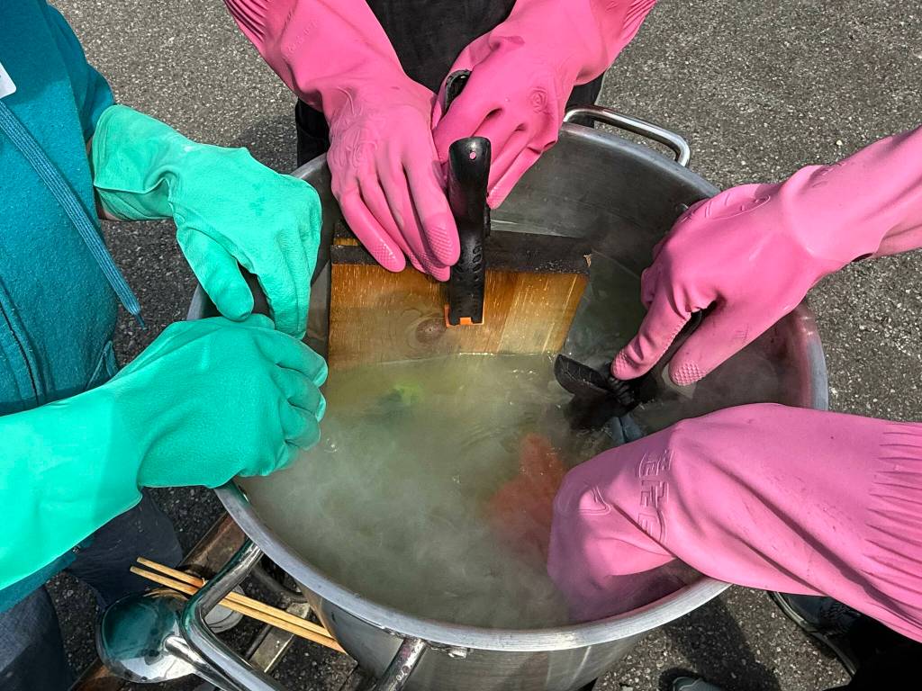 Students wear protective gloves while dying their fabrics to protect themselves from harmful chemicals (Photo by Matt Neinhuis)