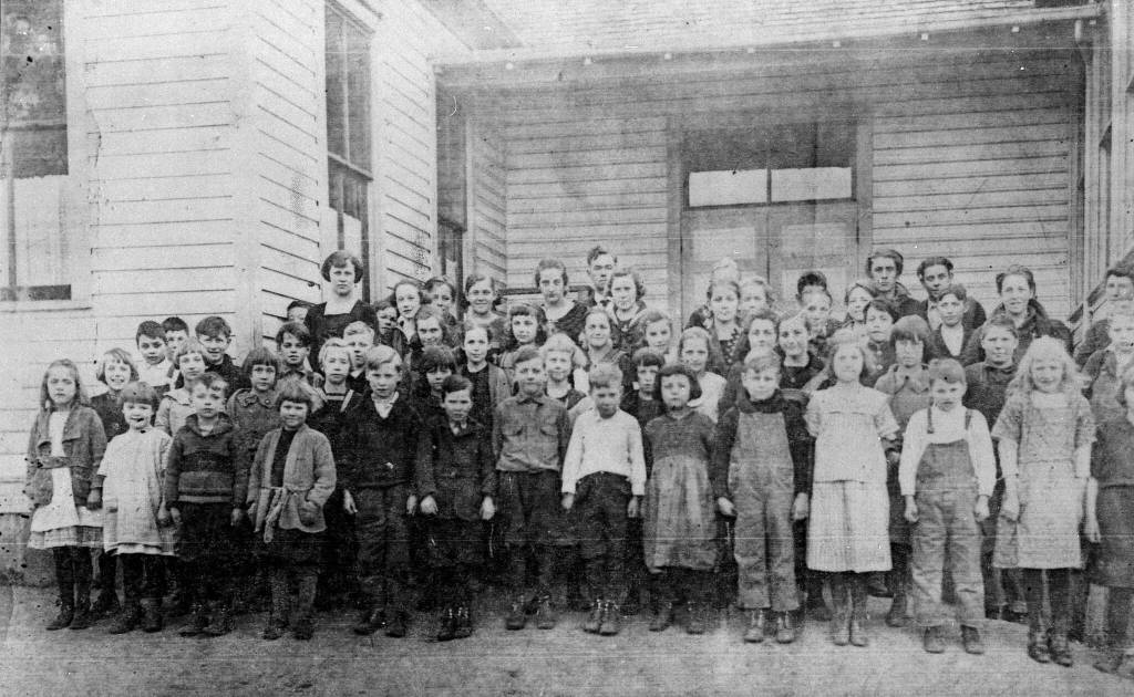 Students stand in front of a schoolhouse that could possibly be the Bayview School (Photo courtesy of the Island County Historical Society)