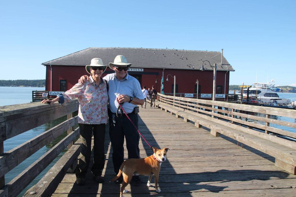 (Photo by Maina Blatt) Rand and Janie Collins and their dog Ginger visit the wharf from Mount Vernon.