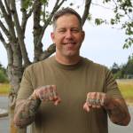 Command Master Chief Ben Faulise shows off his finger tattoos. Photo by Allyson Ballard