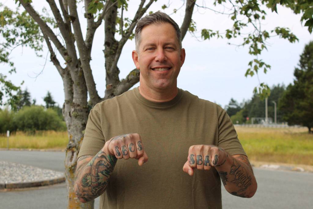 Command Master Chief Ben Faulise shows off his finger tattoos. Photo by Allyson Ballard