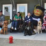 (Photo by Emily Gilbert) Graduates - both human and canine - pose for a photo in front of Summit Assistance Dogs new facility on Jones Road in North Whidbey named Chris Canine Condo.